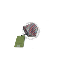 Patterned tie with a Gucci tag on a white background