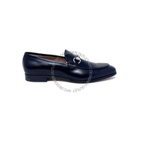 Black loafer shoe with a silver buckle on a white background