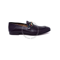 Black leather loafer with decorative buckle on a white background