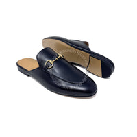 black loafers with gold accents on a white background