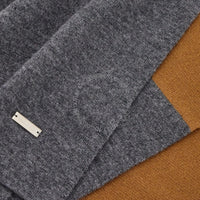 Gray fabric with a label on a brown background