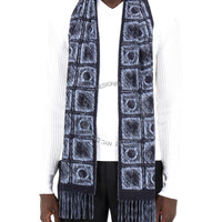 Person wearing a patterned scarf with a white shirt and black pants on a white background