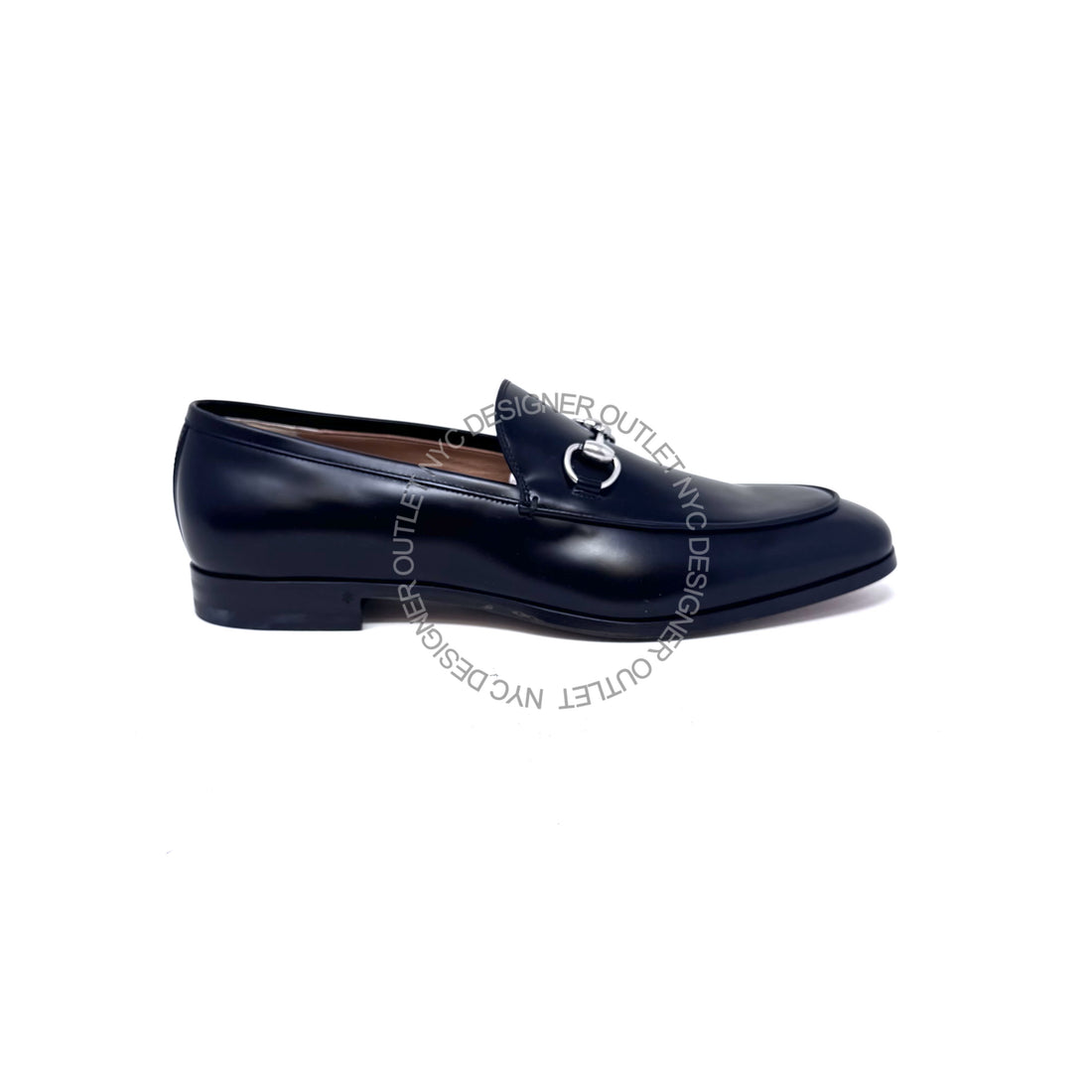 Black loafer shoe with a silver buckle on a white background