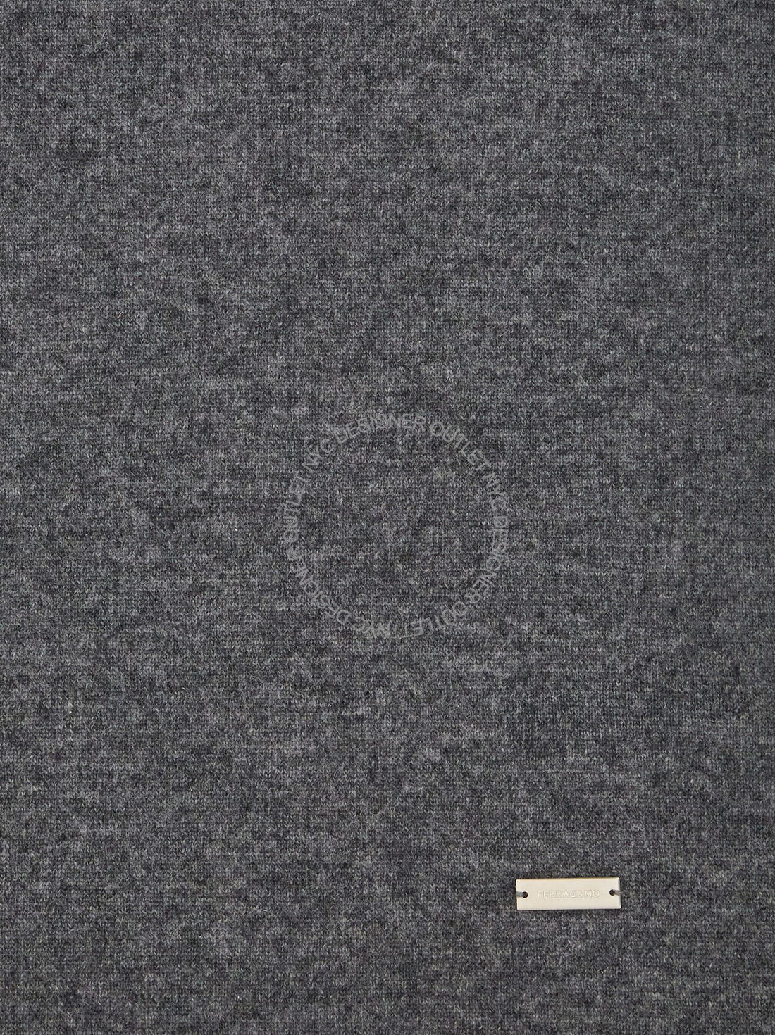 Close-up of gray textured fabric with tag.