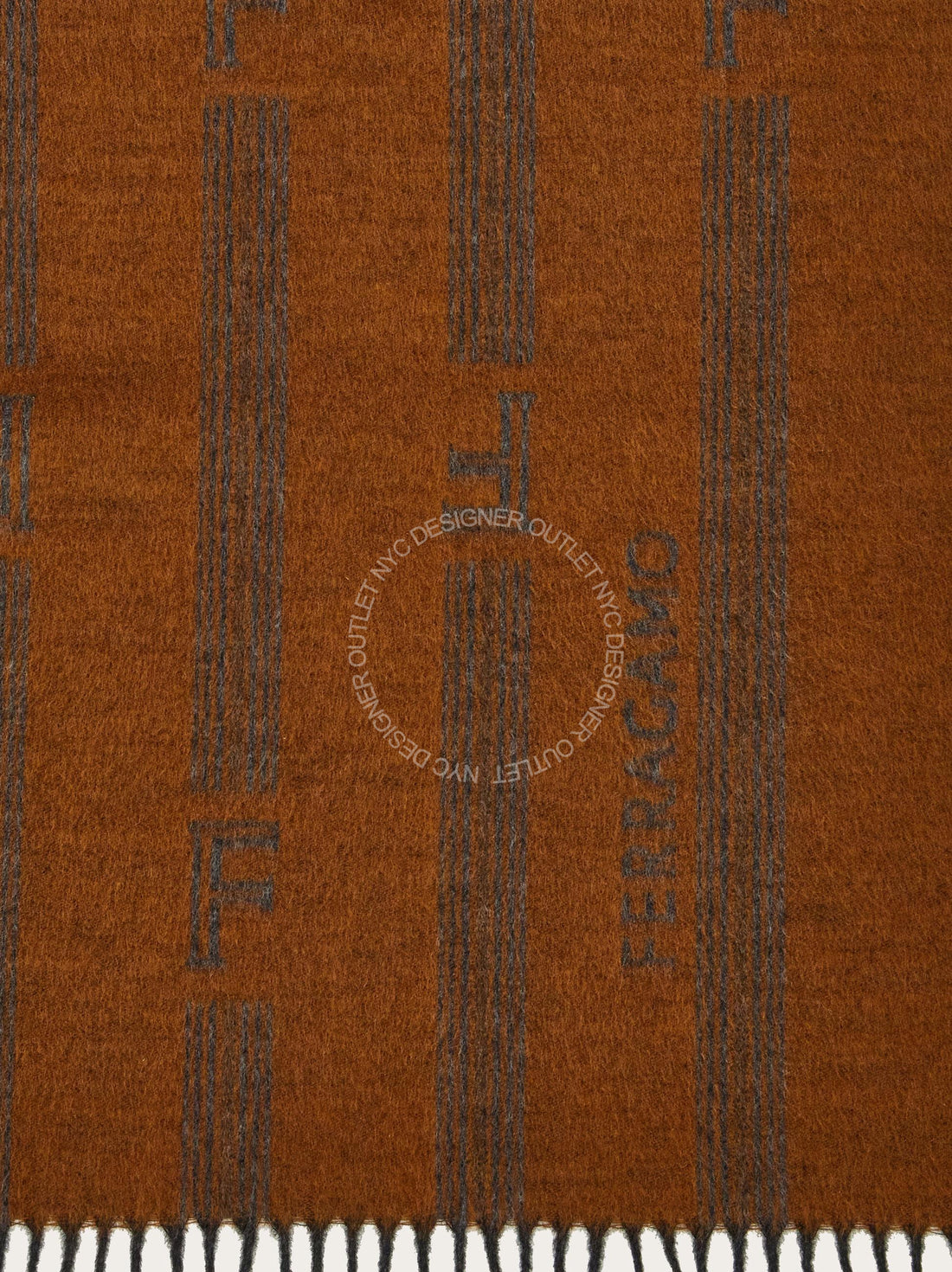Close-up of a brown fabric with a pattern and 'Ferragamo' branding.