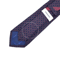 Navy blue patterned tie with a Ferragamo label on a white background