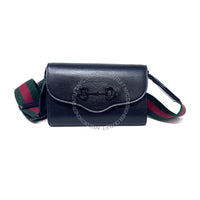 Black handbag with green and red strap on a white background
